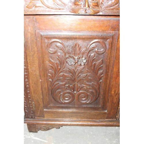 50 - An antique 17th century style carved oak sideboard or chiffonier with mirror back and lion mask hand... 