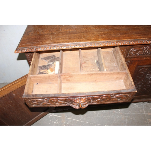 50 - An antique 17th century style carved oak sideboard or chiffonier with mirror back and lion mask hand... 