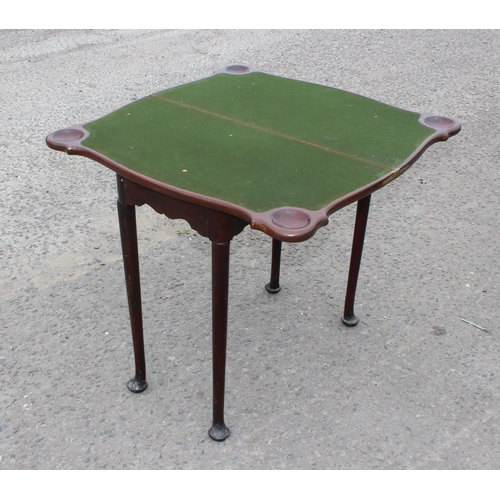 8 - An antique mahogany card table with baize interior and pad feet, approx 79cm square when open