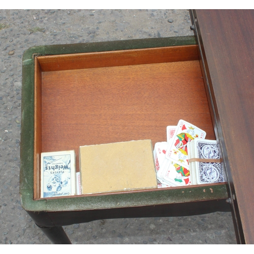 8 - An antique mahogany card table with baize interior and pad feet, approx 79cm square when open