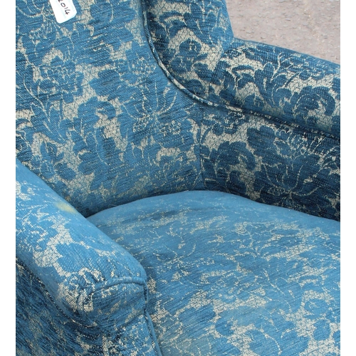 17 - A Victorian low seated armchair with blue patterned upholstery and turned legs