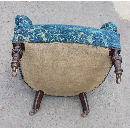 17 - A Victorian low seated armchair with blue patterned upholstery and turned legs