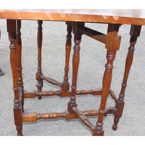 30 - A small antique mahogany Sutherland table with turned legs and a mahogany stool with Pheasant tapest... 