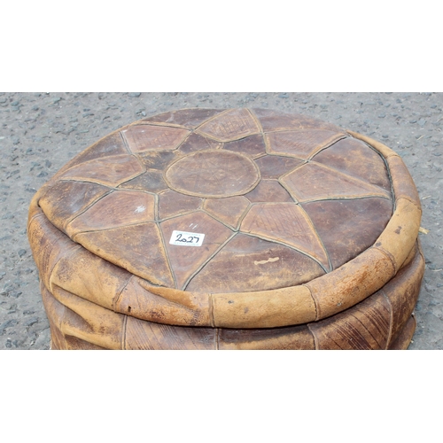 28 - A retro tan leather pouffe or foot stool