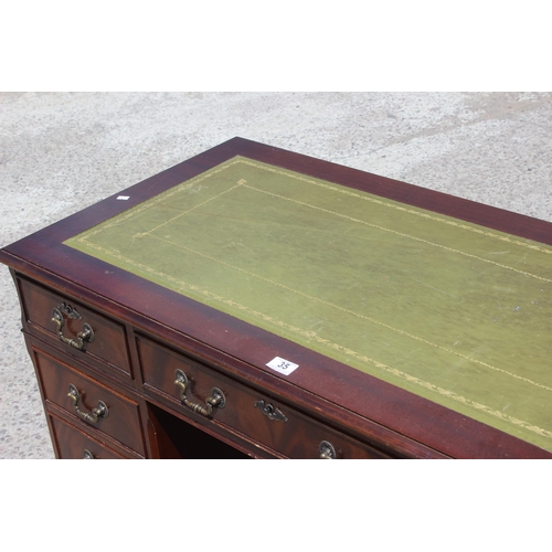 35 - An antique style mahogany pedestal desk with green leather top, approx 122cm wide x 61cm deep x 77cm... 