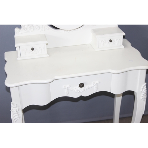 48 - A pair of vintage style white painted dressing table with decorative floral swags and metal handles,... 