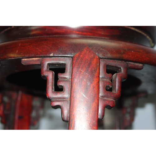 55 - A 20th century Chinese hardwood jardiniere stand with marble inlay, approx 27cm in diameter x 50cm t... 