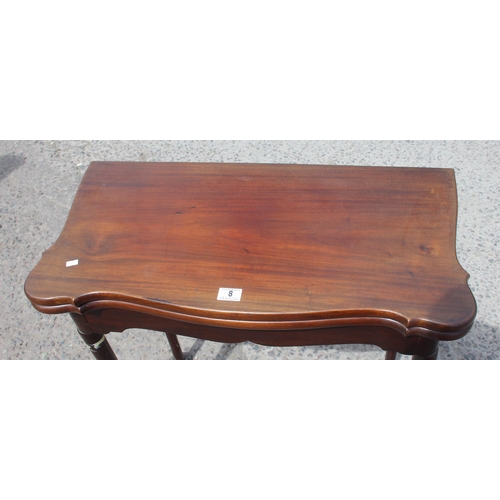 8 - An antique mahogany card table with baize interior and pad feet, approx 79cm square when open