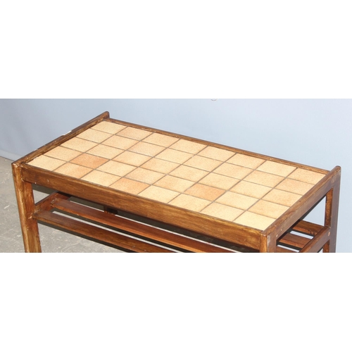 102 - A retro tile topped coffee table with magazine rack, approx 89cm wide x 49cm deep x 41cm tall