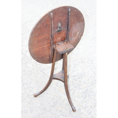 111 - A small antique wooden tilt top mahogany table with unusual tripod base, approx 55cm in diameter