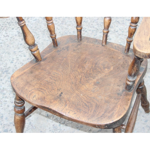 112 - A vintage smoker's bow armchair with elm seat