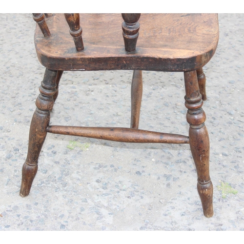 112 - A vintage smoker's bow armchair with elm seat