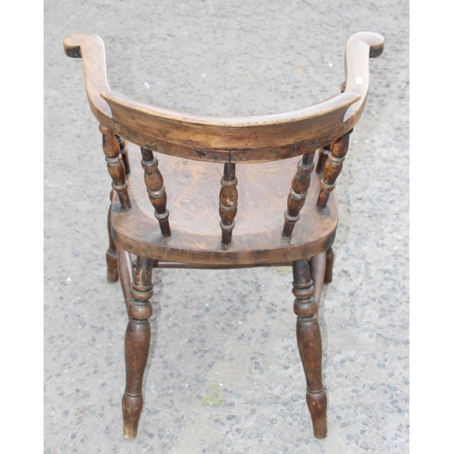 112 - A vintage smoker's bow armchair with elm seat