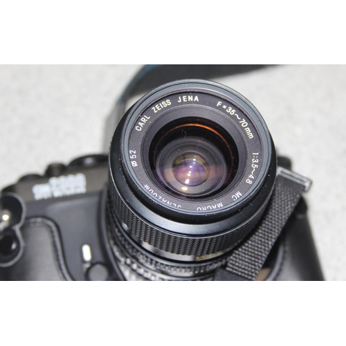 655 - An Olympus OM2000 camera with Zeiss F=35-70mm 1:3.5-4.8 lens, with case and an Olympus OM10 camera b... 