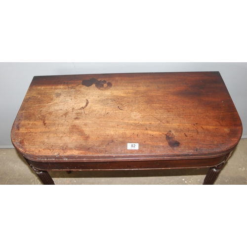 82 - An antique folding mahogany tea table with reeded legs, approx 88cm wide x 88cm deep x 75cm tall