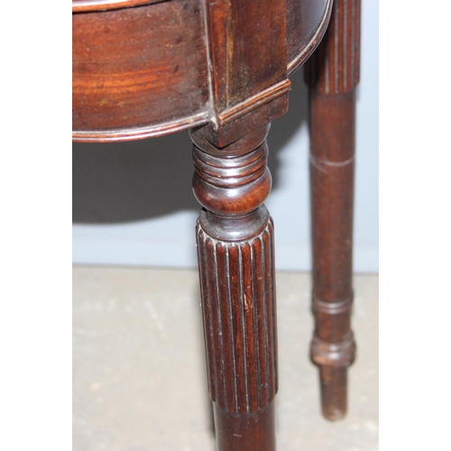 82 - An antique folding mahogany tea table with reeded legs, approx 88cm wide x 88cm deep x 75cm tall