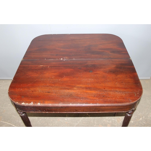 82 - An antique folding mahogany tea table with reeded legs, approx 88cm wide x 88cm deep x 75cm tall