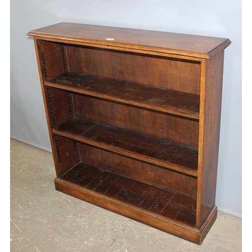 99 - A vintage oak bookcase with adjustable shelves, approx 108cm wide x 29cm deep x 108cm tall