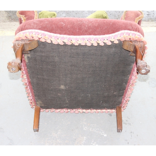 18 - A pair of antique wingback armchairs with later upholstery, short wooden legs ending in carved lion ... 