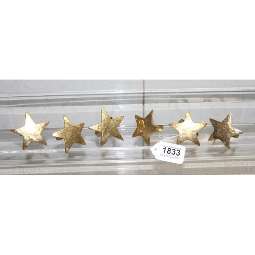 1833 - Set of 6 brass star shaped napkin ring holders with hammered finish.