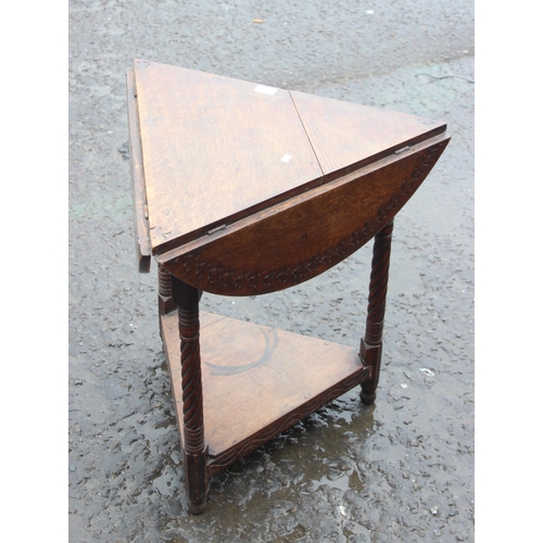 32 - An unusual early 20th century oak drop leaf table of triangular form, when flaps raised the table ma... 