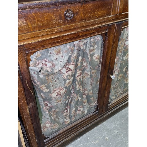 22 - An unusual antique oak display cabinet with 2 pairs of glazed doors and 2 slim drawers, approx 143cm... 