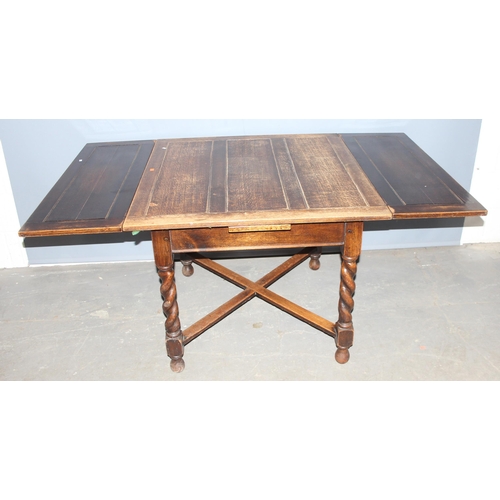 36 - A vintage extending oak dining table with barleytwist legs, approx 92cm wide x 99cm deep x 75cm tall... 