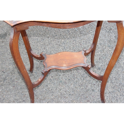 33 - An Edwardian mahogany lamp table with shaped top, approx 64cm wide x 42cm deep x 72cm tall