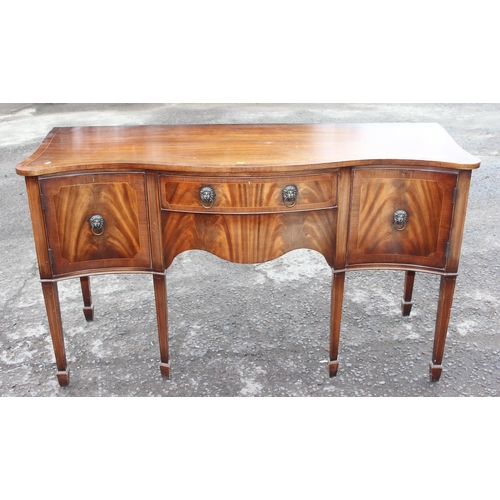 34 - An antique style flame mahogany serpentine sideboard with a central drawer flanked by 2 cupboards, a... 