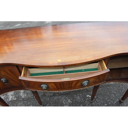 34 - An antique style flame mahogany serpentine sideboard with a central drawer flanked by 2 cupboards, a... 