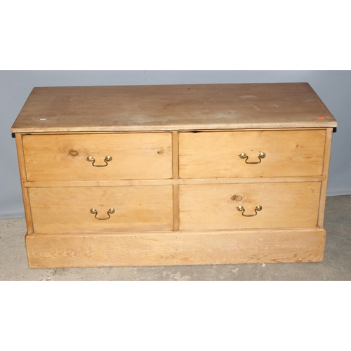 15 - An antique pine 4 drawer low chest of drawers with brass handles, replacement top, approx 124cm wide... 