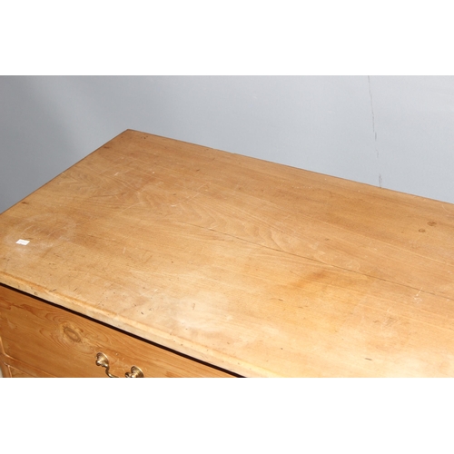 15 - An antique pine 4 drawer low chest of drawers with brass handles, replacement top, approx 124cm wide... 