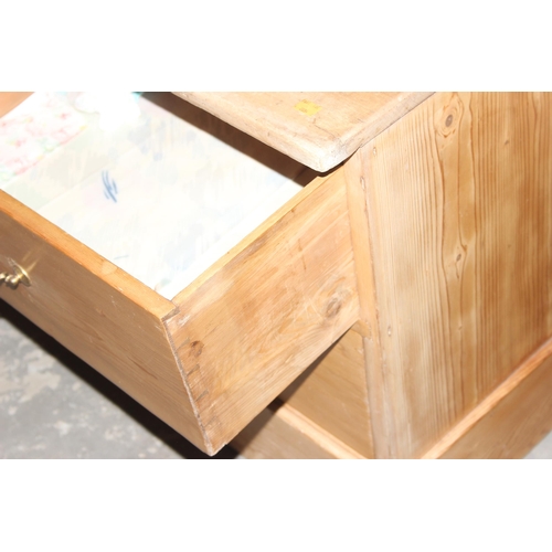 15 - An antique pine 4 drawer low chest of drawers with brass handles, replacement top, approx 124cm wide... 