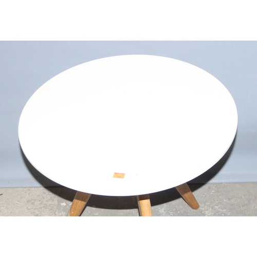 24 - A retro Scandinavian style tripod table with white top, approx 50cm in diameter x 50cm tall