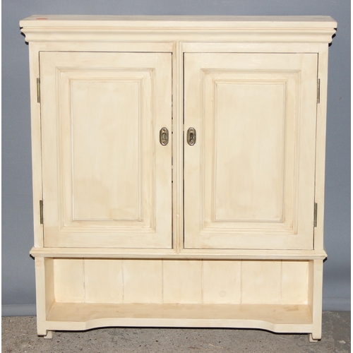 25 - A cream painted pine wall hanging cupboard, approx 64cm wide x 14cm deep x 74cm tall