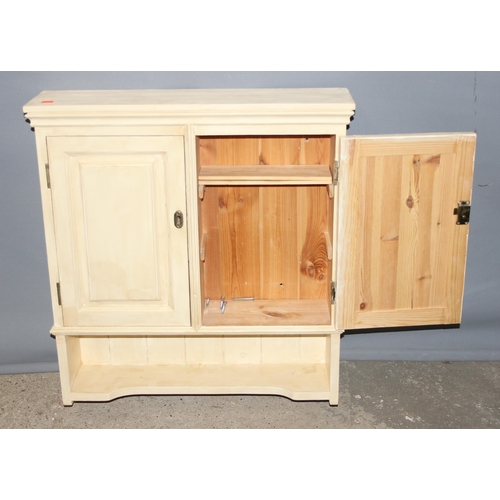 25 - A cream painted pine wall hanging cupboard, approx 64cm wide x 14cm deep x 74cm tall