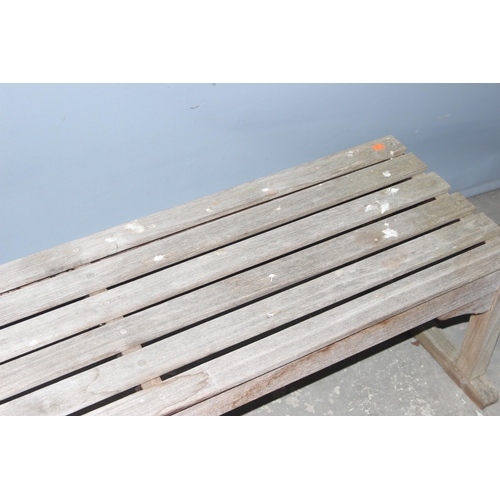 301 - A weathered slatted teak garden bench by Barlow Tyrie of Braintree, approx 149cm wide x 56cm deep x ... 