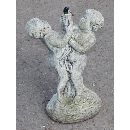 306 - A small concrete garden fountain formed as 2 cherubs, approx 52cm tall