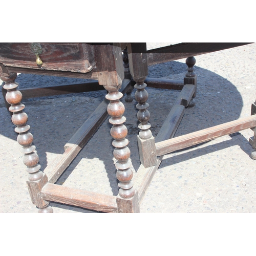 48 - An antique oak dropleaf table with turned supports and single drawer, likely 18th century, approx 15... 