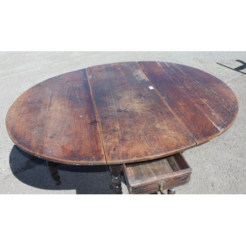 48 - An antique oak dropleaf table with turned supports and single drawer, likely 18th century, approx 15... 