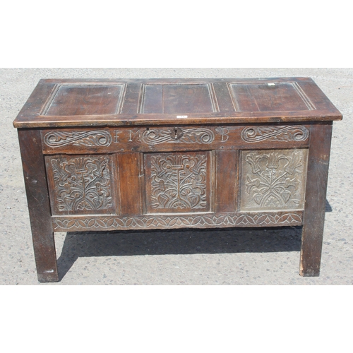 51 - An 18th century oak coffer with carved details, approx 120cm wide x 54cm deep x 71cm tall