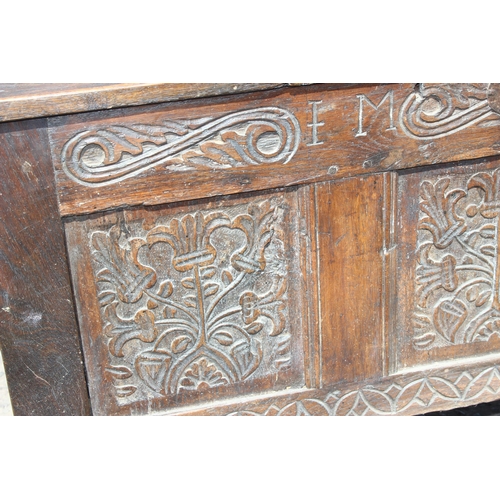 51 - An 18th century oak coffer with carved details, approx 120cm wide x 54cm deep x 71cm tall