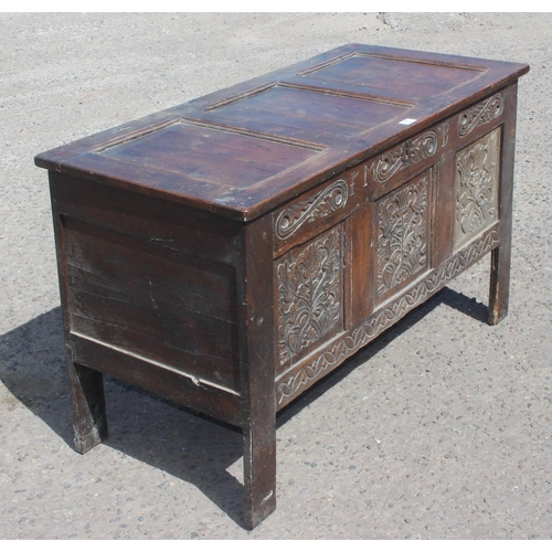 51 - An 18th century oak coffer with carved details, approx 120cm wide x 54cm deep x 71cm tall