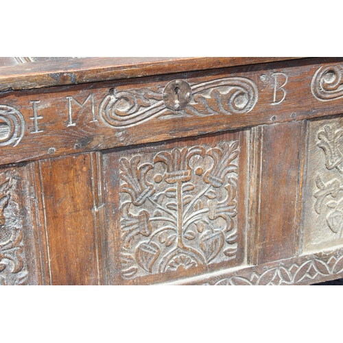 51 - An 18th century oak coffer with carved details, approx 120cm wide x 54cm deep x 71cm tall