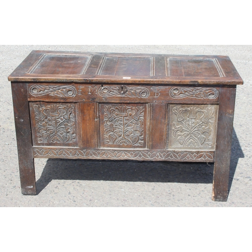 51 - An 18th century oak coffer with carved details, approx 120cm wide x 54cm deep x 71cm tall