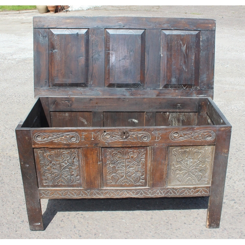 51 - An 18th century oak coffer with carved details, approx 120cm wide x 54cm deep x 71cm tall