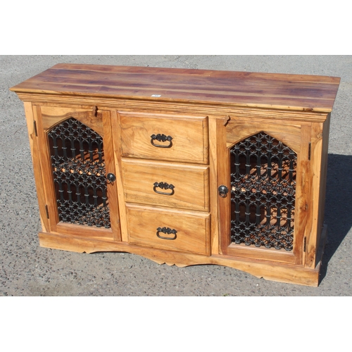 65 - A 20th century heavy wooden sideboard with wrought iron grills, possibly Mangowood, approx 146cm wid... 