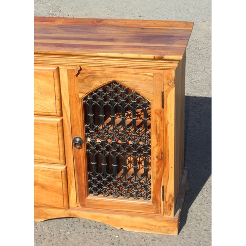 65 - A 20th century heavy wooden sideboard with wrought iron grills, possibly Mangowood, approx 146cm wid... 