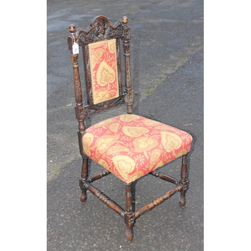 76 - A Carolean style carved oak hall chair with upholstered seat and back, likely 19th century