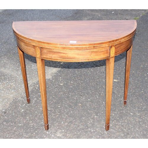 77 - A Georgian mahogany demi-lune card table with marquetry inlay, approx 90cm in diameter when open, ap... 